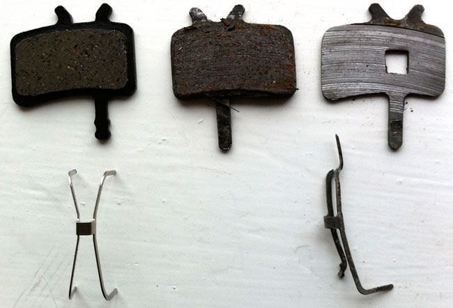 When disc brakes go wrong. Left - new pad. Middle - worn pad. Right - my pad.