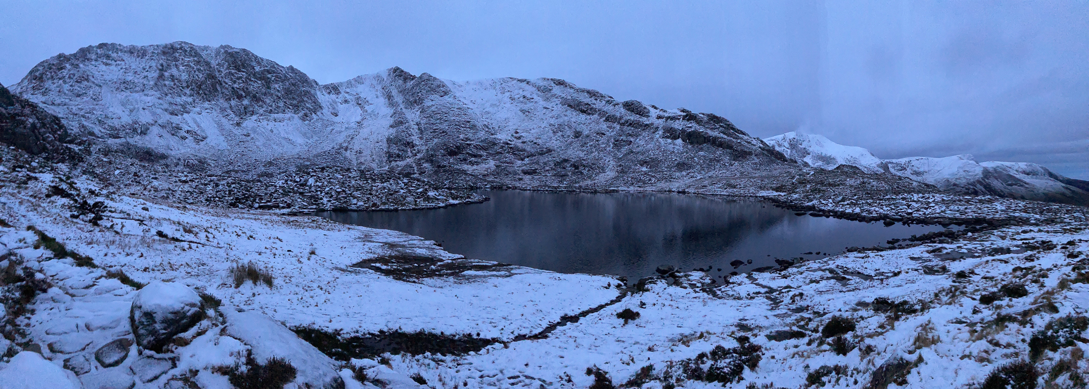 Snowy mountains with a lake in the foreground. © Haydn Williams 2025