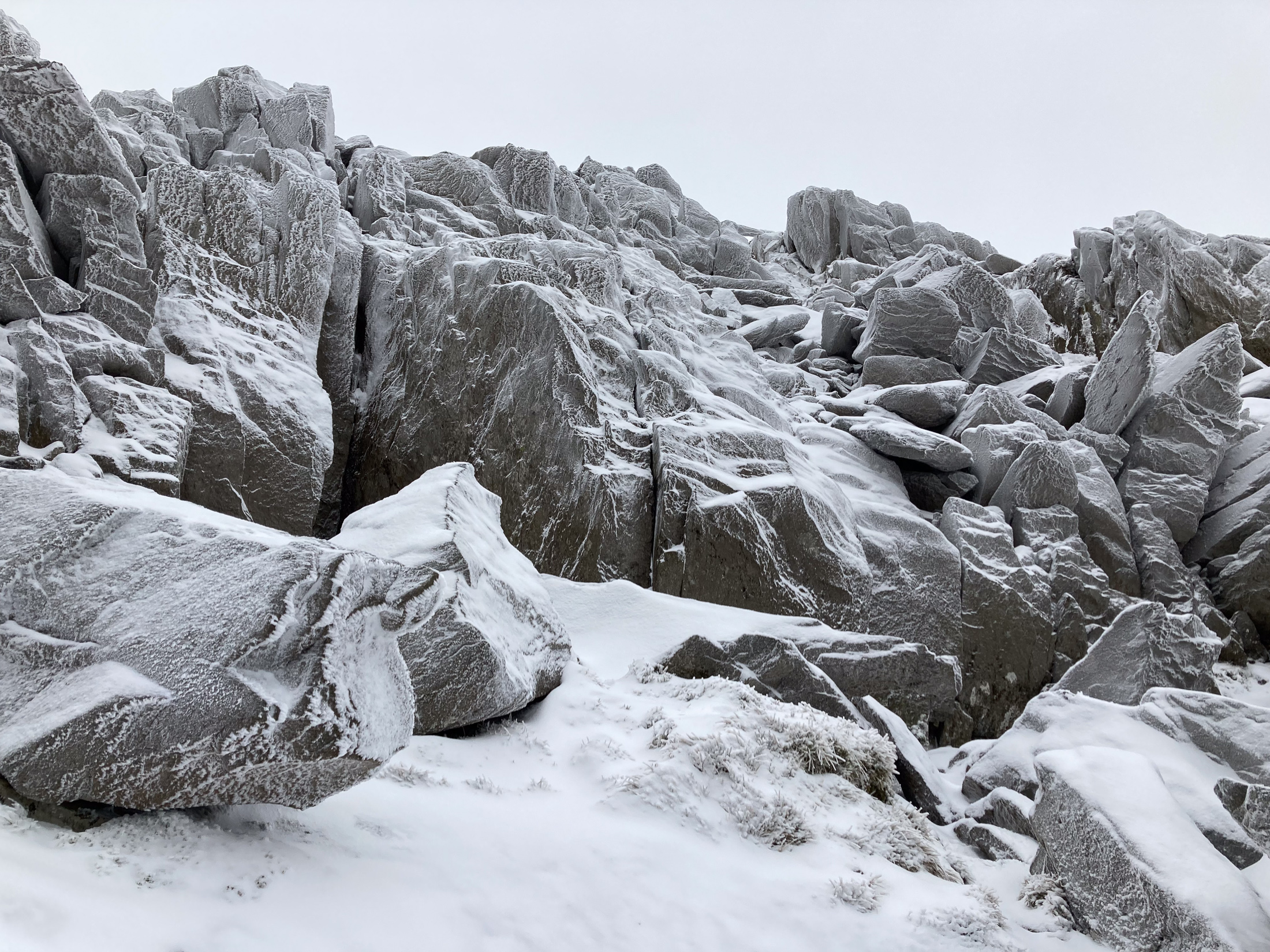 Snowy rocks on a mountain summit. © Haydn Williams 2025