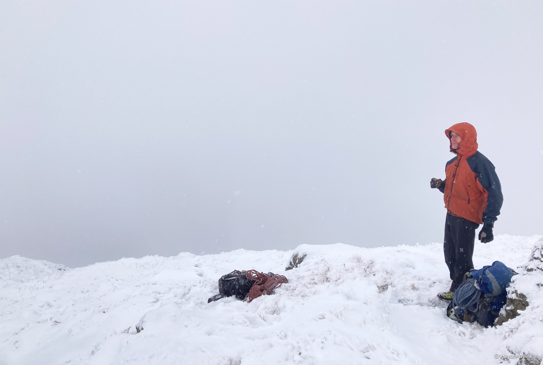Climber on a mountainside. There is cloud all around and no view. © Haydn Williams 2025
